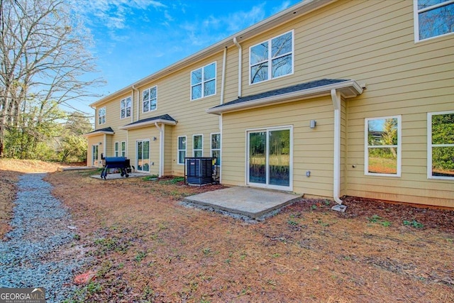 back of house featuring central AC unit and a patio area