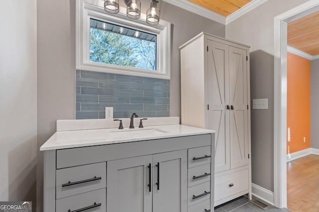 bathroom with vanity, hardwood / wood-style floors, and crown molding