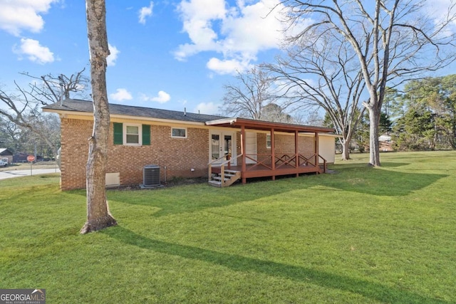 rear view of house with a wooden deck, a lawn, and central air condition unit