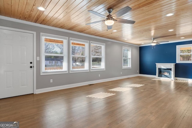 unfurnished living room with ceiling fan, hardwood / wood-style flooring, ornamental molding, and wooden ceiling