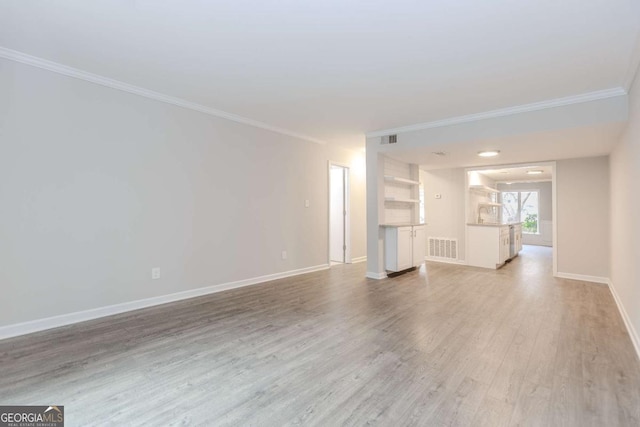 unfurnished living room with crown molding and light hardwood / wood-style floors