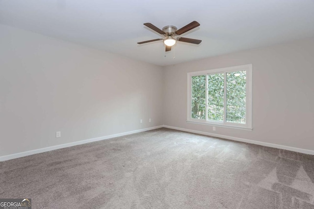 carpeted empty room featuring ceiling fan