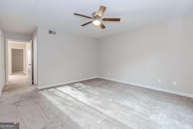 carpeted spare room featuring ceiling fan