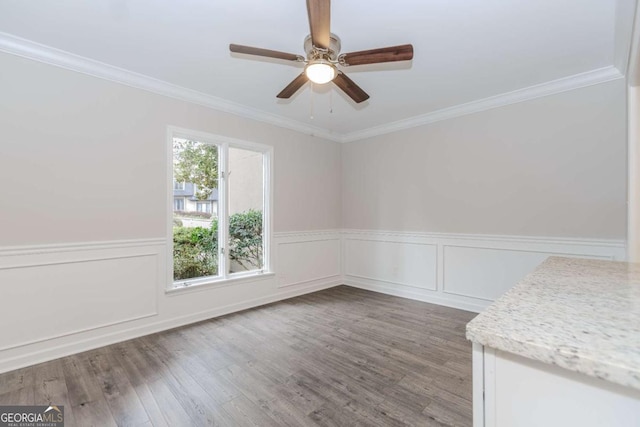 spare room featuring crown molding, ceiling fan, and hardwood / wood-style floors