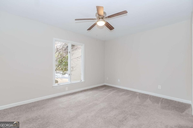 unfurnished room featuring light colored carpet and ceiling fan