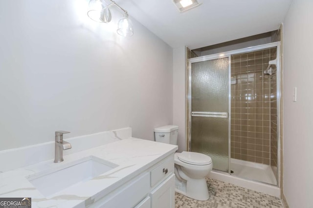 bathroom featuring toilet, vanity, and walk in shower