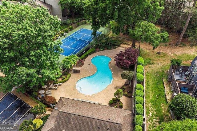 view of pool with tennis court and a patio