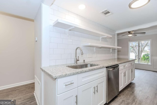 kitchen with white cabinetry, sink, decorative backsplash, stainless steel dishwasher, and light stone countertops