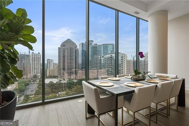 dining room featuring hardwood / wood-style flooring and floor to ceiling windows