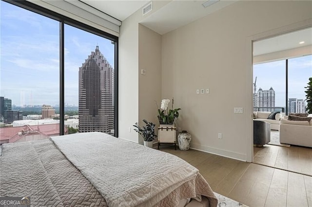 bedroom featuring hardwood / wood-style flooring and multiple windows