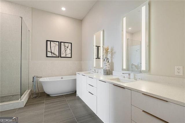 bathroom with vanity and independent shower and bath