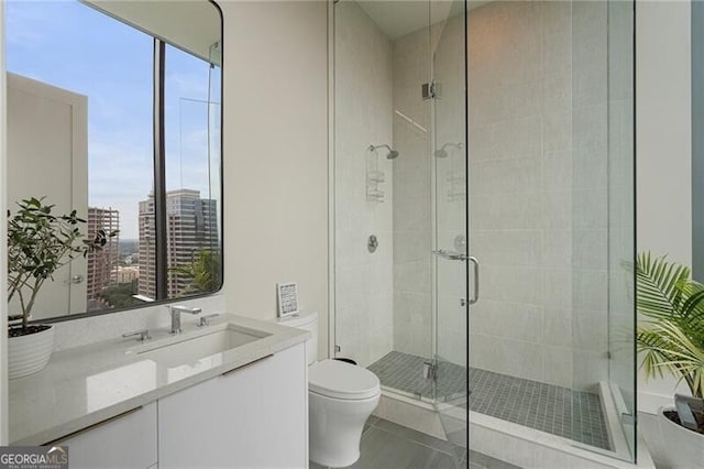 bathroom featuring walk in shower, vanity, toilet, and tile patterned flooring