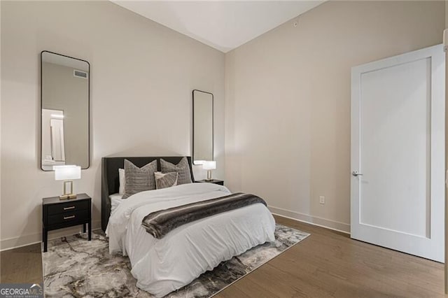 bedroom featuring lofted ceiling and wood-type flooring