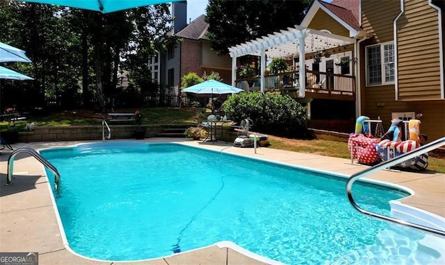 view of pool with a pergola and a patio