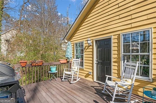 wooden terrace featuring area for grilling