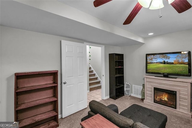 living room featuring light colored carpet and ceiling fan