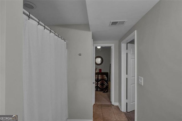 hall featuring light tile patterned flooring