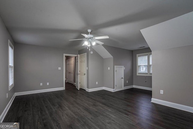 additional living space with dark wood-style flooring, ceiling fan, and baseboards