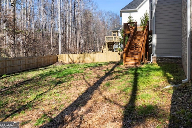 view of yard with stairs and fence