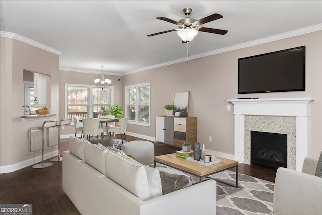 living room featuring baseboards, ornamental molding, and dark wood-style flooring