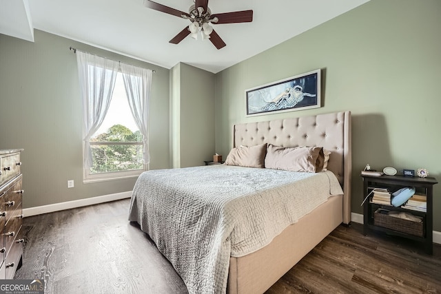 bedroom with dark hardwood / wood-style flooring and ceiling fan