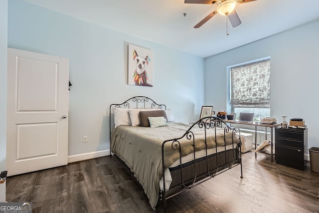 bedroom with dark hardwood / wood-style flooring and ceiling fan