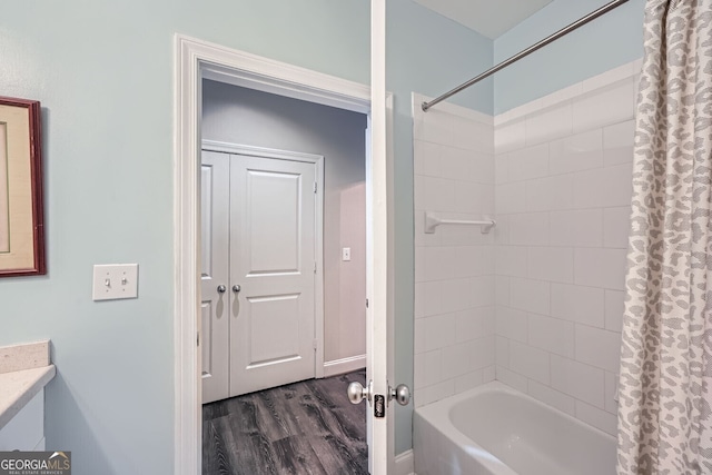 bathroom featuring hardwood / wood-style flooring and shower / tub combo