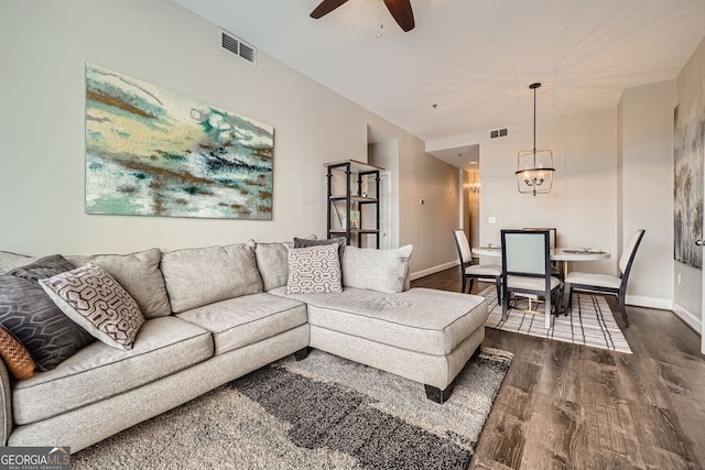 living room with dark wood-type flooring and ceiling fan