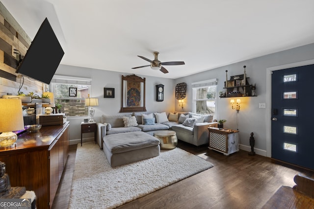 living area with ceiling fan, baseboards, and wood finished floors