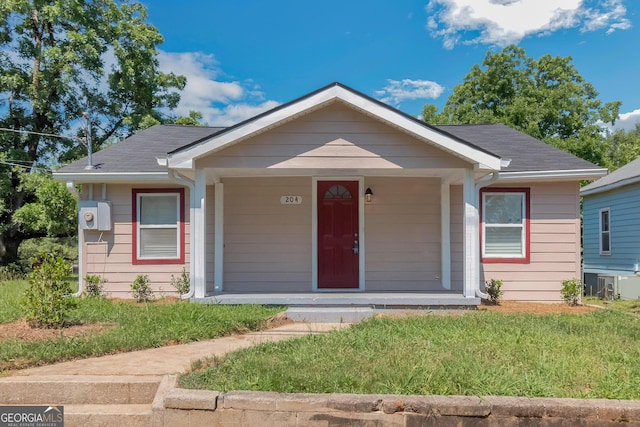 bungalow with a front yard and covered porch