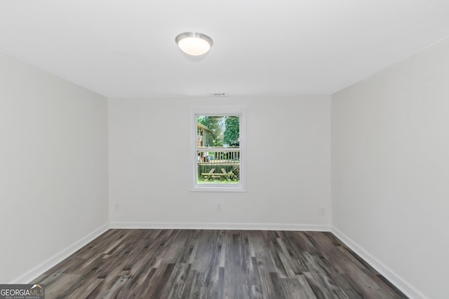 empty room with dark hardwood / wood-style floors