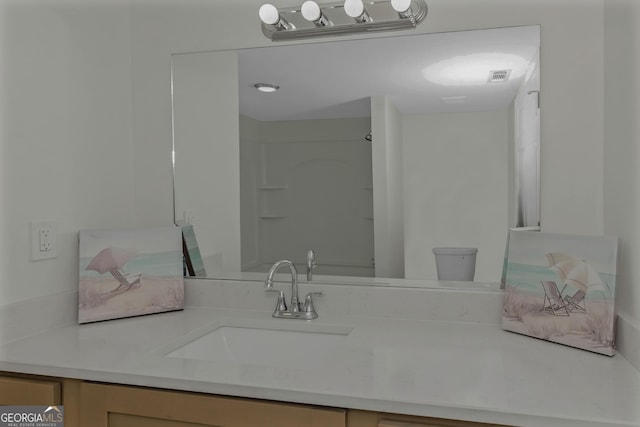 bathroom with vanity and toilet