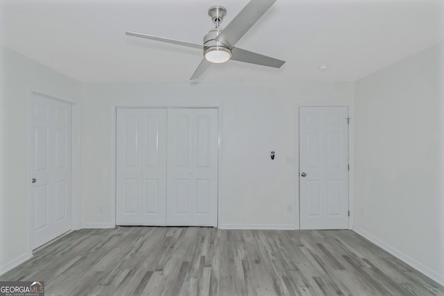 unfurnished bedroom featuring ceiling fan, light hardwood / wood-style floors, and a closet