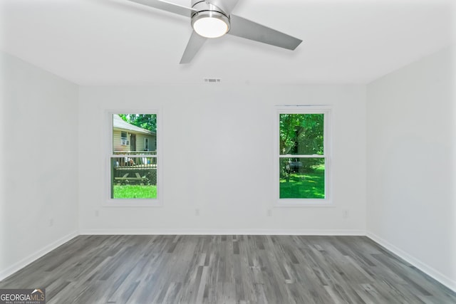 empty room with hardwood / wood-style flooring and ceiling fan