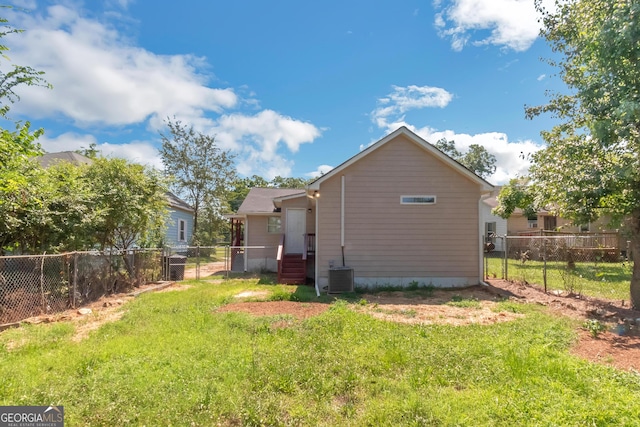 exterior space with cooling unit and a lawn