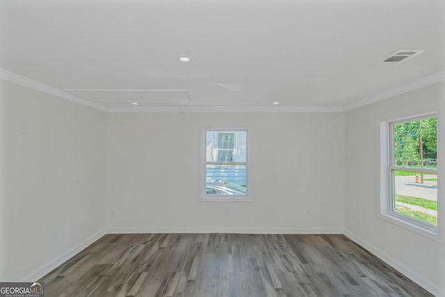 empty room with light hardwood / wood-style flooring and ornamental molding