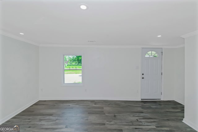 spare room featuring crown molding and dark wood-type flooring