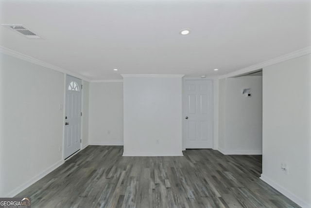 unfurnished room with ornamental molding and dark hardwood / wood-style flooring