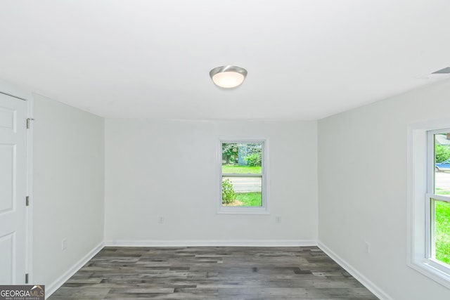 spare room featuring dark hardwood / wood-style flooring