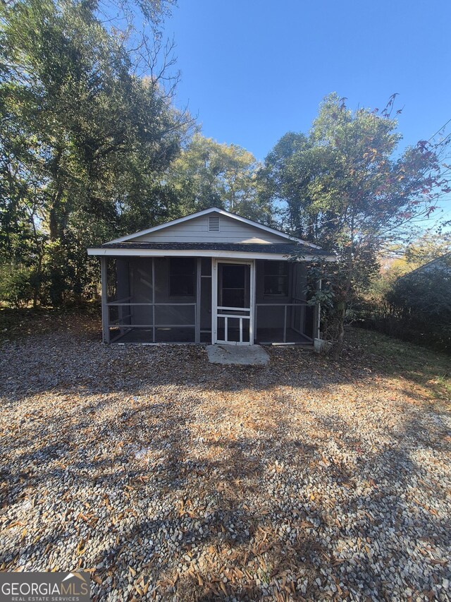 view of front of home featuring a sunroom