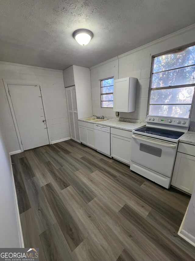 kitchen featuring white appliances, dark hardwood / wood-style floors, a textured ceiling, and white cabinets