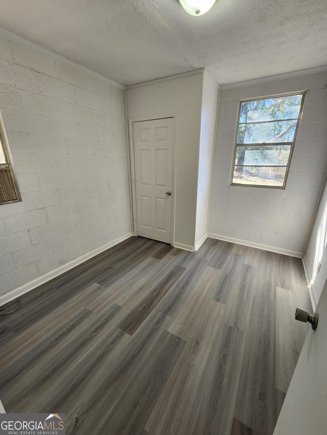 unfurnished bedroom with dark wood-type flooring and a textured ceiling