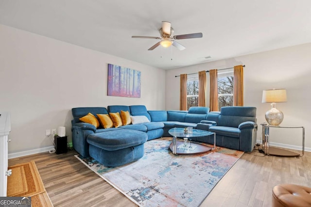 living room featuring ceiling fan and wood-type flooring