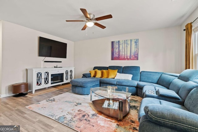 living room featuring wood-type flooring and ceiling fan