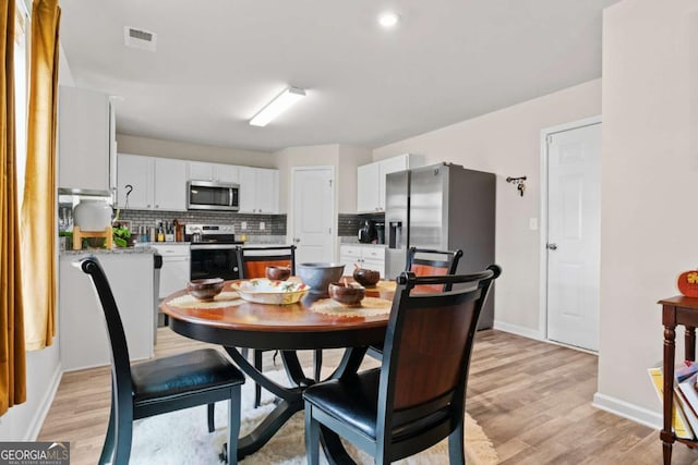 dining area featuring light hardwood / wood-style flooring