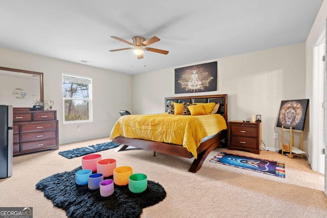 bedroom with light colored carpet and ceiling fan