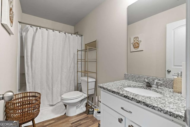 bathroom featuring vanity, wood-type flooring, and toilet