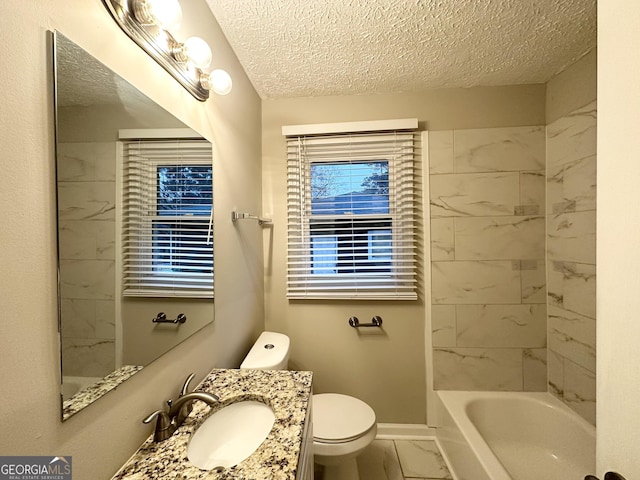 bathroom featuring vanity, toilet, and a textured ceiling