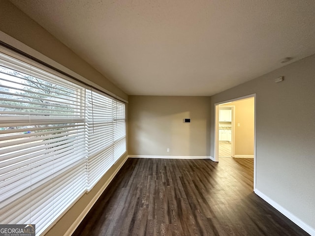 spare room with dark hardwood / wood-style flooring