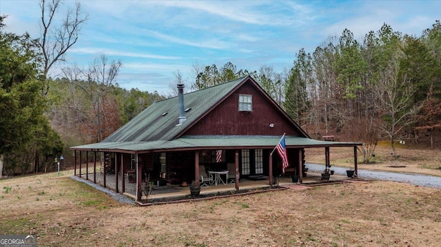 back of property featuring french doors, a patio area, and a lawn